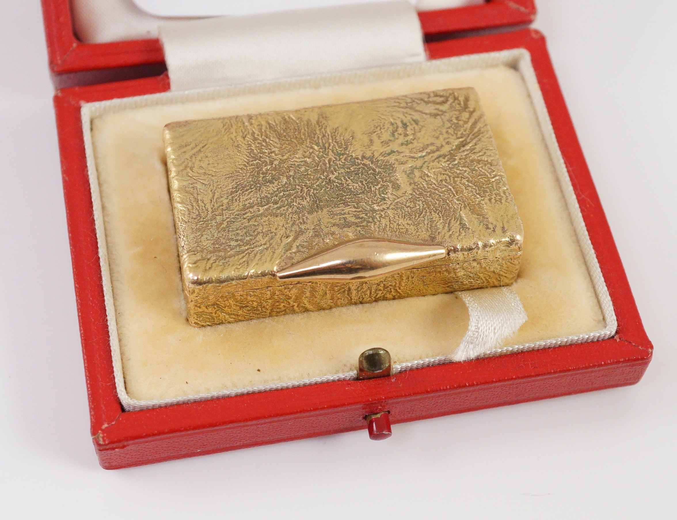 A 1960's 9ct gold Cartier rectangular pill box, with samorodok decoration